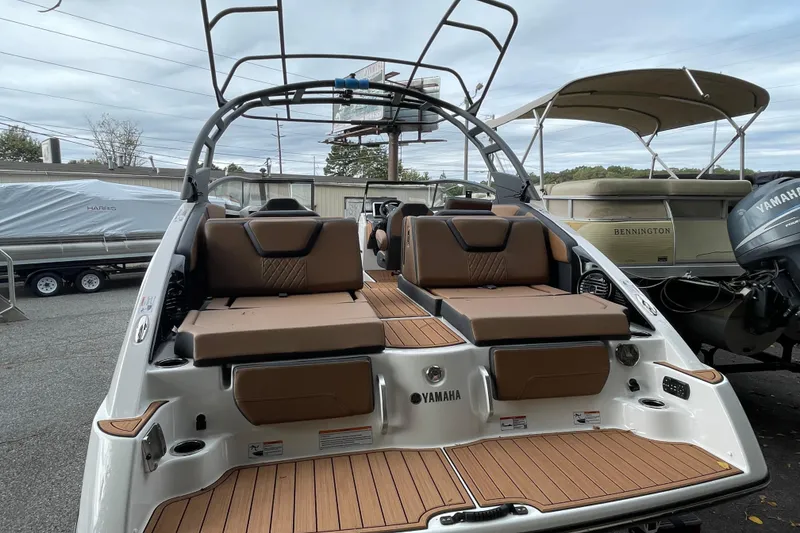 Slide: The Image of 2026 Yamaha Boats 252SD with sleek design and comfortable seating in a marina setting. - 19