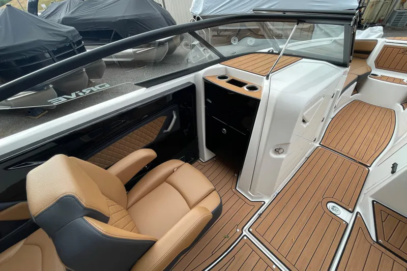 Slide: The Image of 2026 Yamaha Boats 252SD interior with tan seating and wood-style flooring. - 5