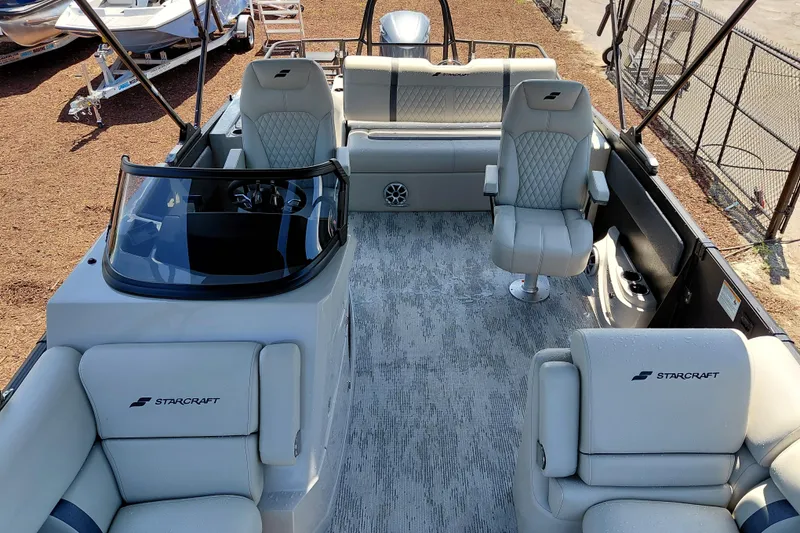Slide: The Image of Luxurious 2026 Starcraft RX 23 Q DH boat interior with plush seating and modern helm. - 11