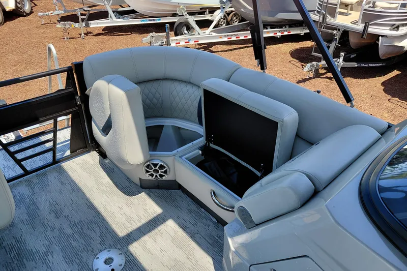 Slide: The Image of 2026 Starcraft RX 23 Q DH boat interior with gray seating and storage compartment. - 13