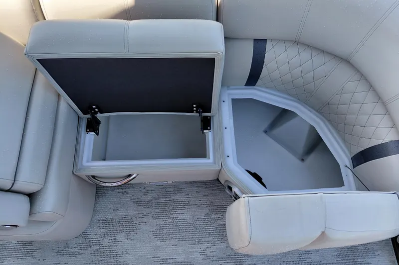 Slide: The Image of 2026 Starcraft RX 23 Q DH boat interior with open storage compartments. - 14