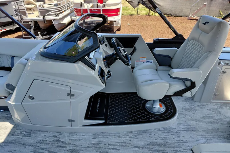 Slide: The Image of Captain's seat and helm of 2026 Starcraft RX 23 Q DH boat, featuring modern controls. - 18