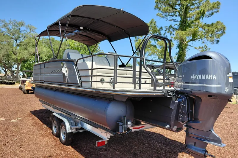 Slide: The Image of 2026 Starcraft RX 23 Q DH pontoon boat with Yamaha engine on trailer. - 2