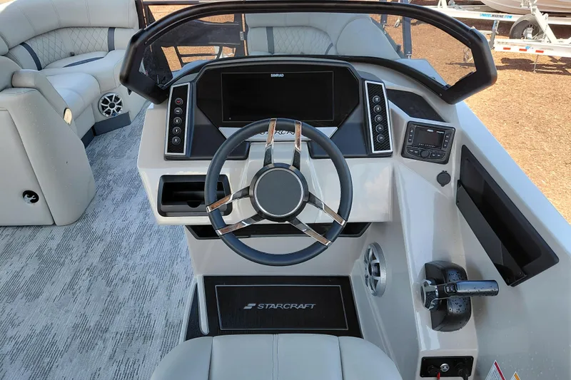 Slide: The Image of 2026 Starcraft RX 23 Q DH boat dashboard with modern steering and control panel. - 20