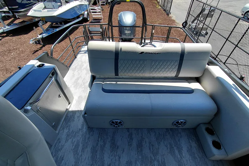 Slide: The Image of 2026 Starcraft RX 23 Q DH boat interior with seating, storage, and motor view. - 23