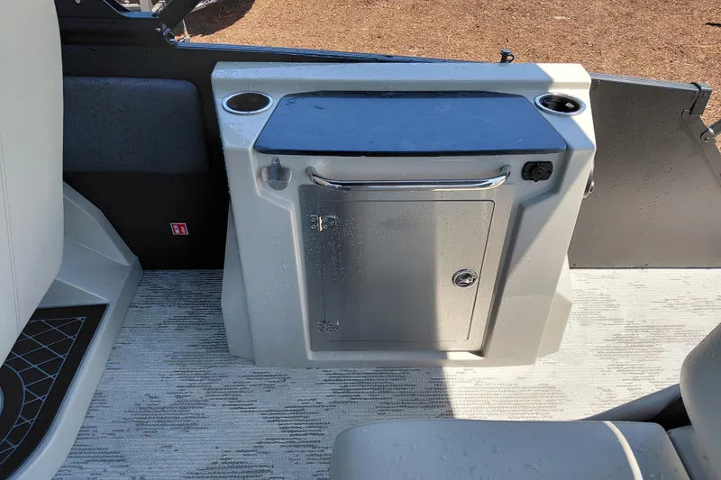 Slide: The Image of Interior of 2026 Starcraft RX 23 Q DH boat with storage compartment and cup holders. - 25