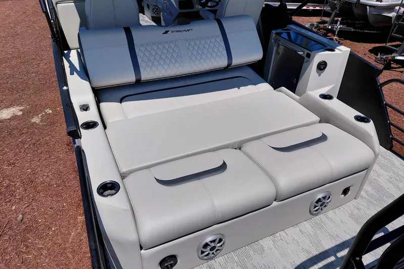 Slide: The Image of Luxurious seating on 2026 Starcraft RX 23 Q DH boat, featuring cup holders and speakers. - 27