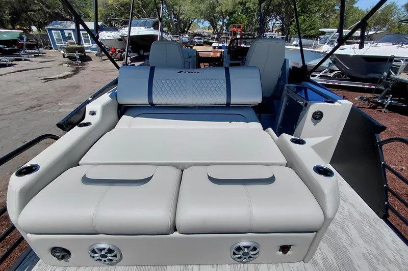 Slide: The Image of 2026 Starcraft RX 23 Q DH boat interior with luxurious seating and cup holders. - 28