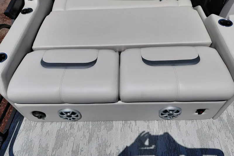 Slide: The Image of Luxurious seating on 2026 Starcraft RX 23 Q DH boat with integrated speakers and cup holders. - 29