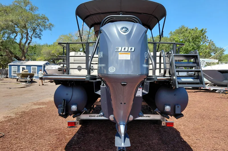 Slide: The Image of 2026 Starcraft RX 23 Q DH boat with Yamaha 300 engine, parked outdoors. - 3