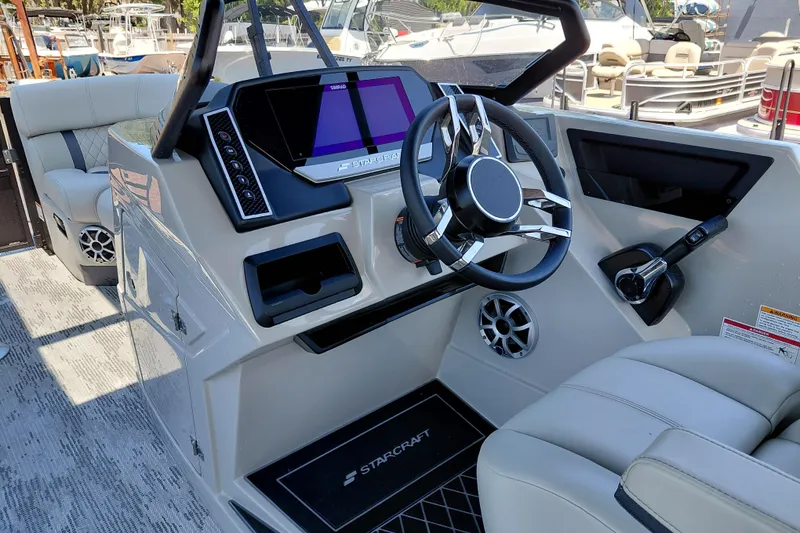 Slide: The Image of Modern Starcraft RX 23 Q DH boat interior with sleek dashboard and steering wheel, 2026 model. - 39