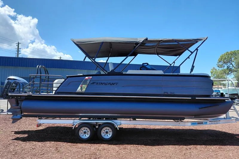 Slide: The Image of 2026 Starcraft RX 23 Q DH pontoon boat on trailer, featuring sleek design and canopy. - 5