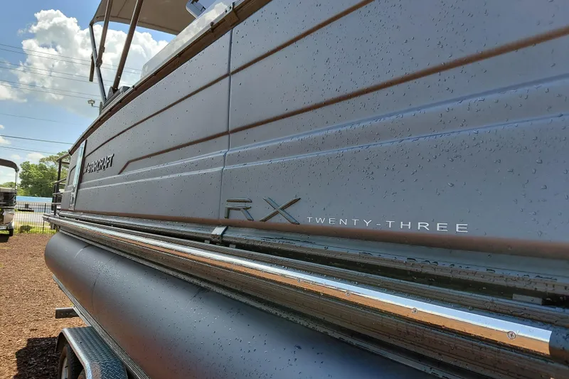 Slide: The Image of 2026 Starcraft RX 23 Q DH pontoon boat with sleek design and modern features. - 7