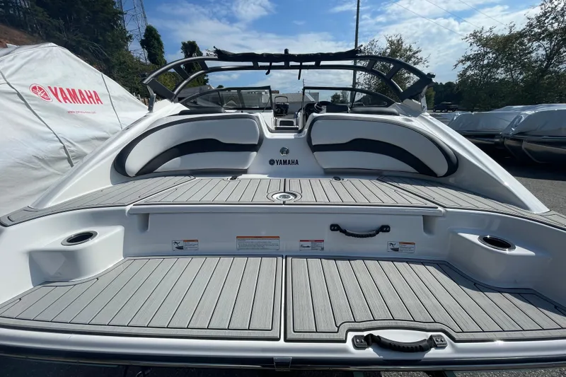 Slide: The Image of 2026 Yamaha Boats AR195, rear view, showcasing spacious deck and seating area. - 18