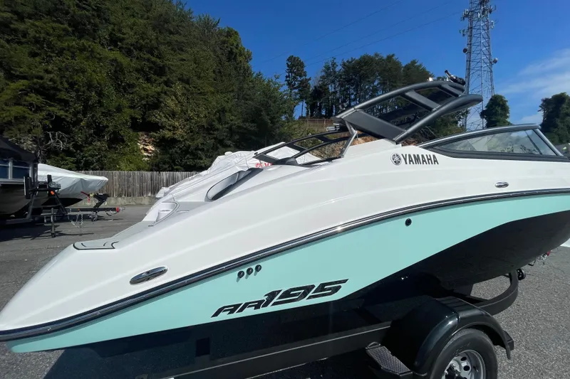 Slide: The Image of 2026 Yamaha AR195 boat on trailer, sleek design, parked outdoors. - 2