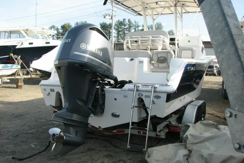 Slide: The Image of 2020 Sea Fox 249 Avenger boat with Yamaha engine on trailer in marina setting. - 2