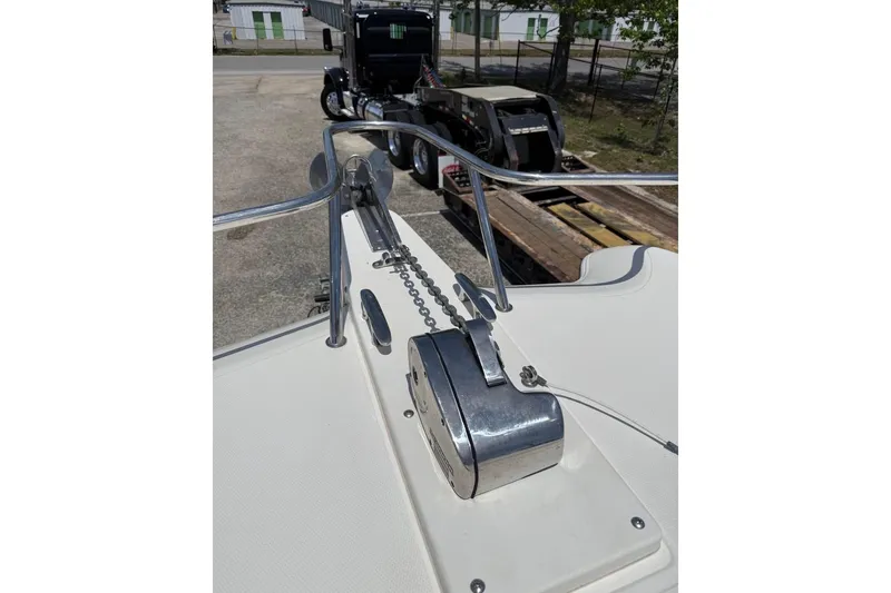 Slide: The Image of 2006 World Cat 270 EC boat anchor system with chain, parked near a truck. - 10
