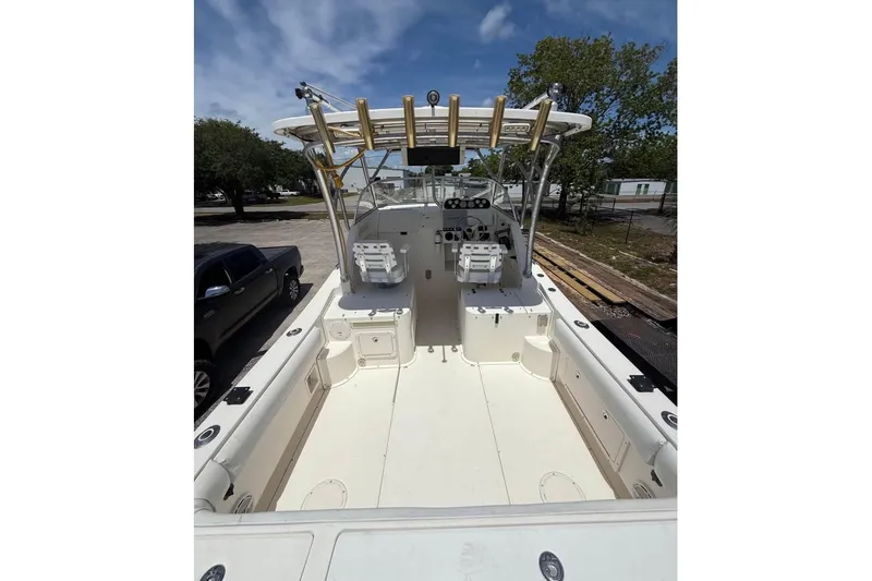 Slide: The Image of 2006 World Cat 270 EC boat interior with dual seats and open deck under a clear sky. - 4