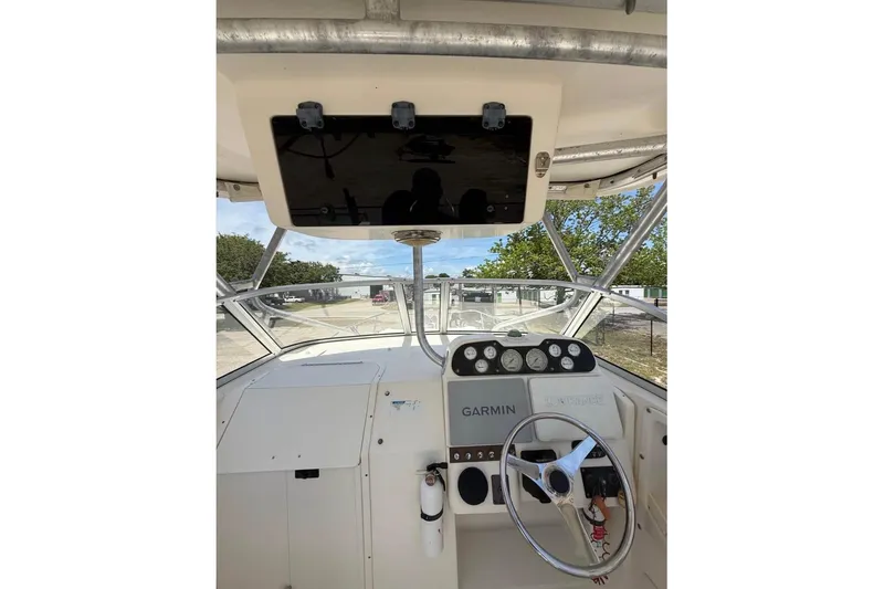 Slide: The Image of 2006 World Cat 270 EC boat cockpit with Garmin navigation system and steering wheel. - 8