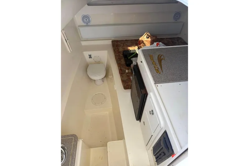 Slide: The Image of Interior of 2006 World Cat 270 EC boat with toilet and compact kitchenette. - 9
