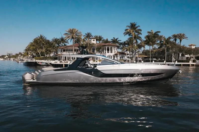 The Image of 2021 Azimut Verve 47 yacht cruising near luxury waterfront homes and palm trees. - 1