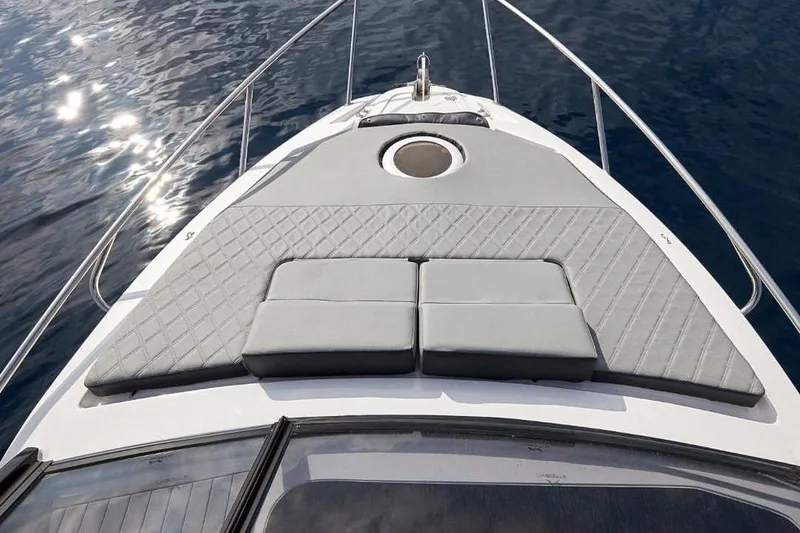 Slide: The Image of Sun deck of 2025 NX Boats NX270 on calm water. - 5