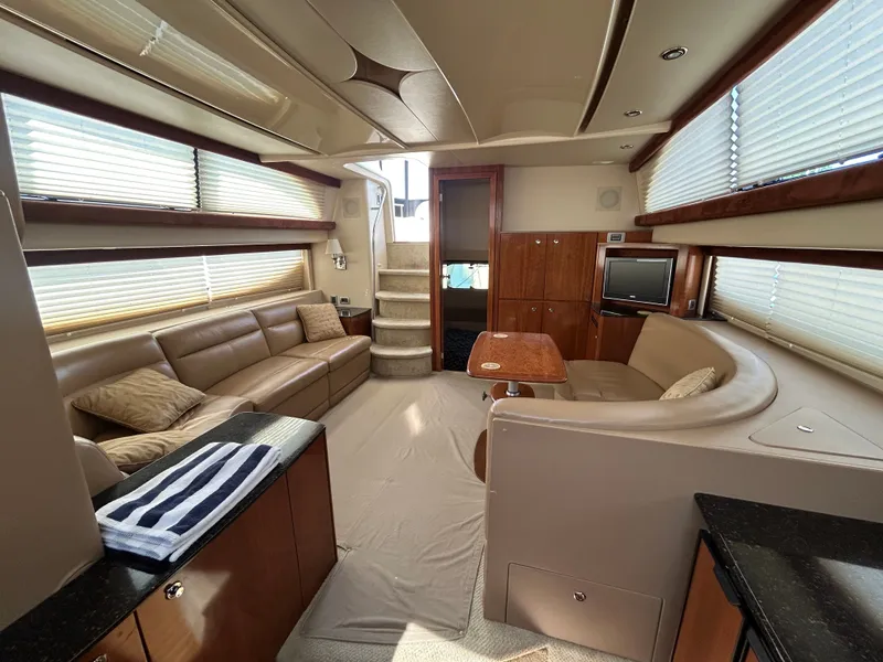 Slide: The Image of Interior of a 2007 Meridian 368 Motoryacht with beige sofa, table, and TV. - 33
