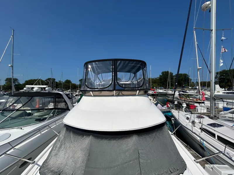 Slide: The Image of A 2007 Meridian 368 Motoryacht docked in a marina, surrounded by other boats. - 35