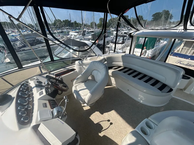 Slide: The Image of The image shows the cockpit of a 2007 Meridian 368 Motoryacht with white leather seating and a helm station. - 13