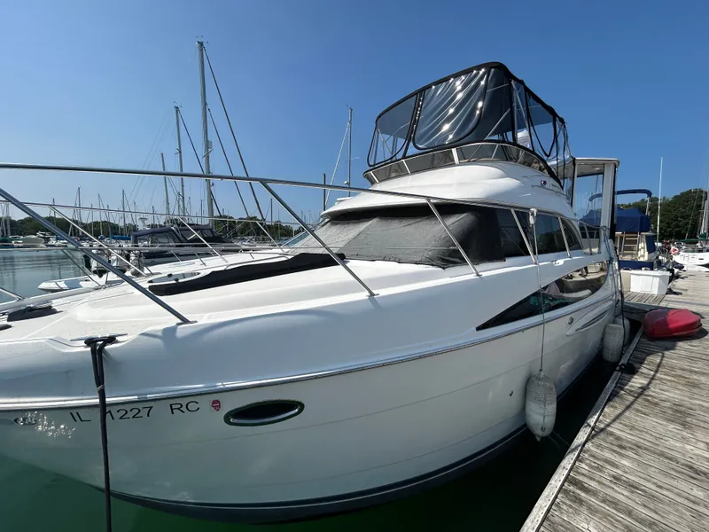 Slide: The Image of A white 2007 Meridian 368 Motoryacht docked. It features a covered upper deck. - 38
