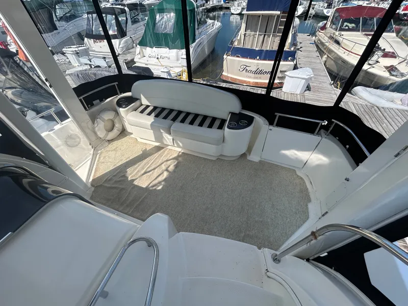 Slide: The Image of The 2007 Meridian 368 Motoryacht features a spacious cockpit with white seating and surrounding windows. - 15