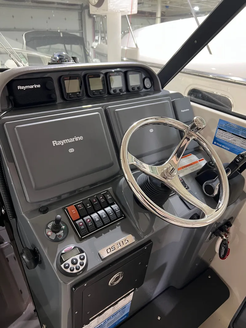 Slide: The Image of 2008 Pursuit OS 315 Offshore helm with Raymarine equipment. - 14