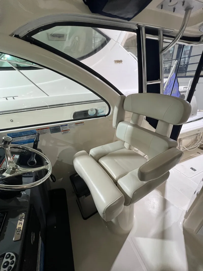 Slide: The Image of Interior of a 2008 Pursuit OS 315 Offshore boat with steering wheel and seat. - 16