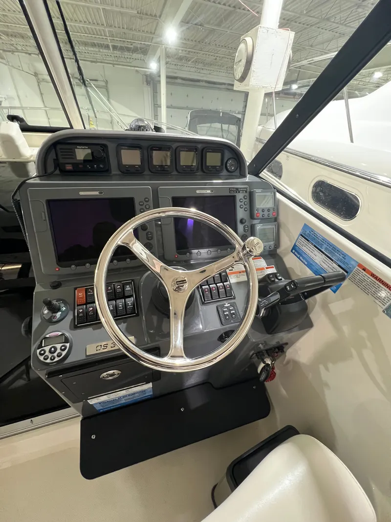 Slide: The Image of 2008 Pursuit OS 315 Offshore helm with modern navigation instruments. - 17