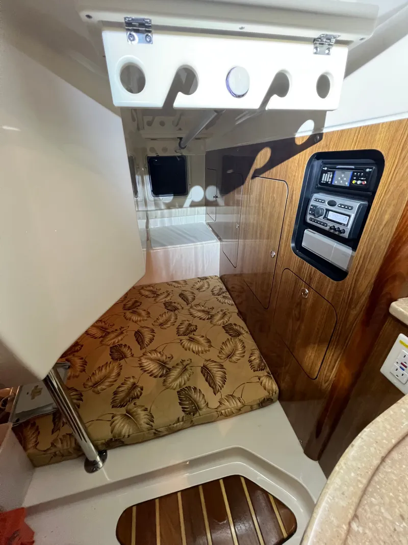 Slide: The Image of Interior of a 2008 Pursuit OS 315 Offshore with cushion and wood paneling. - 31