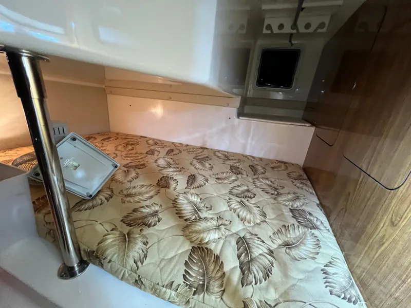 Slide: The Image of Interior of 2008 Pursuit OS 315 Offshore with bed and wood paneling. - 32