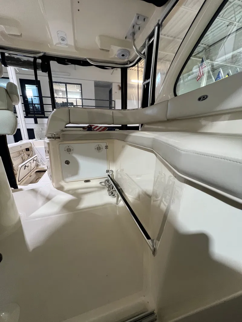 Slide: The Image of Interior of a 2008 Pursuit OS 315 Offshore with white upholstery. - 8