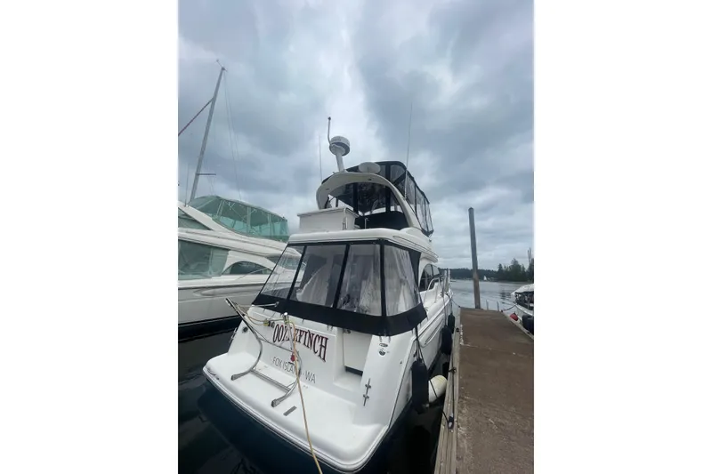 Slide: The Image of 2004 Meridian 341 Sedan yacht docked under cloudy skies. - 2
