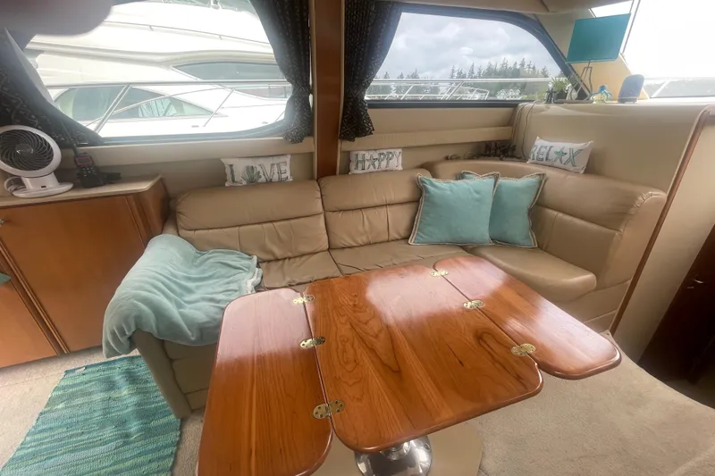 Slide: The Image of Luxurious interior of a 2004 Meridian 341 Sedan yacht with cozy seating and decorative pillows. - 10
