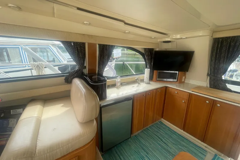 Slide: The Image of Interior of 2004 Meridian 341 Sedan yacht with kitchenette, TV, and seating area. - 11