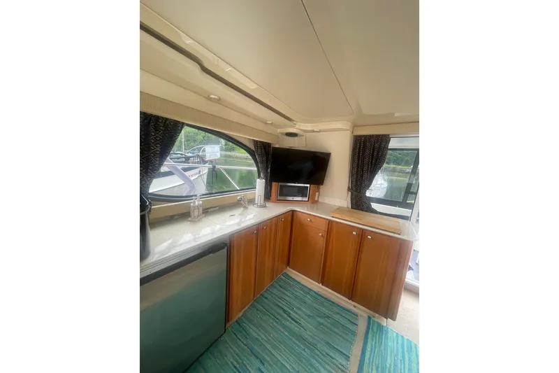 Slide: The Image of Interior of 2004 Meridian 341 Sedan yacht with modern kitchen and scenic window view. - 12