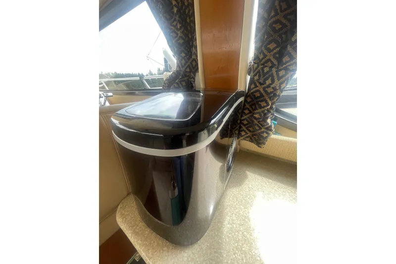 Slide: The Image of Ice maker inside a 2004 Meridian 341 Sedan yacht, near patterned curtains and window. - 15