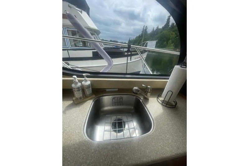 Slide: The Image of Interior view of a 2004 Meridian 341 Sedan yacht kitchen sink with window view. - 17