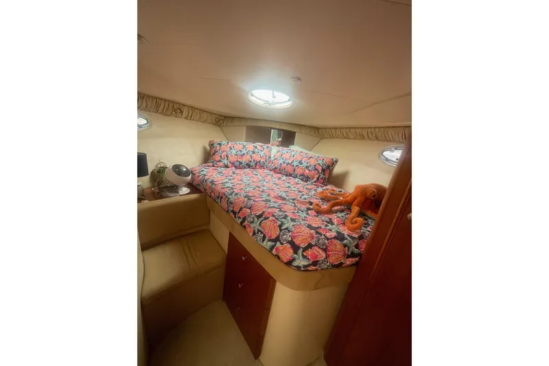 Slide: The Image of Cozy cabin interior of 2004 Meridian 341 Sedan with floral bedding and plush toy. - 20