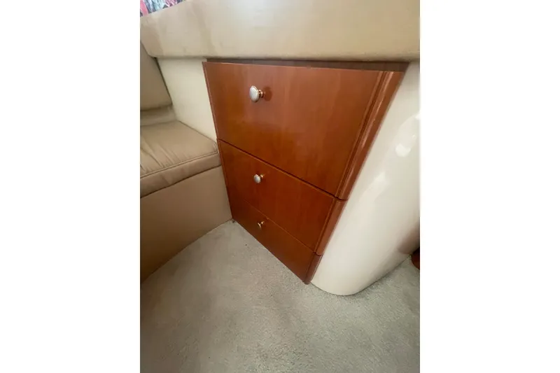 Slide: The Image of Wooden cabinet drawers in a 2004 Meridian 341 Sedan interior. - 21