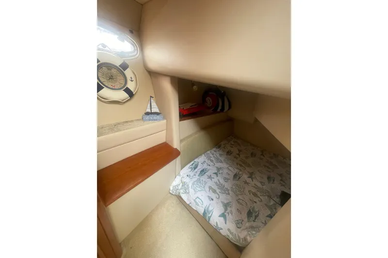 Slide: The Image of Cozy cabin interior of 2004 Meridian 341 Sedan with nautical decor and patterned bedding. - 23
