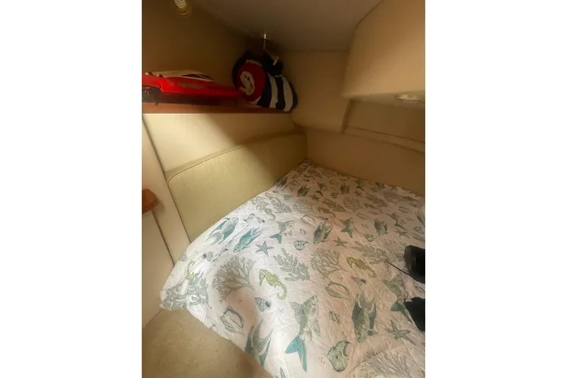 Slide: The Image of Cozy cabin interior of 2004 Meridian 341 Sedan with nautical-themed bedding. - 24