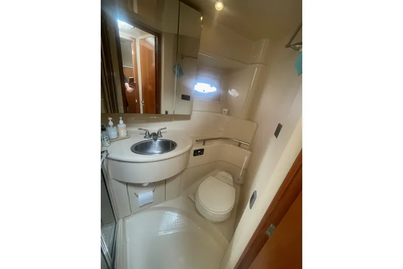 Slide: The Image of Compact bathroom in 2004 Meridian 341 Sedan yacht with sink, toilet, and mirror. - 25