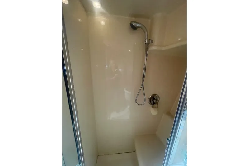 Slide: The Image of Shower area inside a 2004 Meridian 341 Sedan yacht, featuring a handheld showerhead. - 26