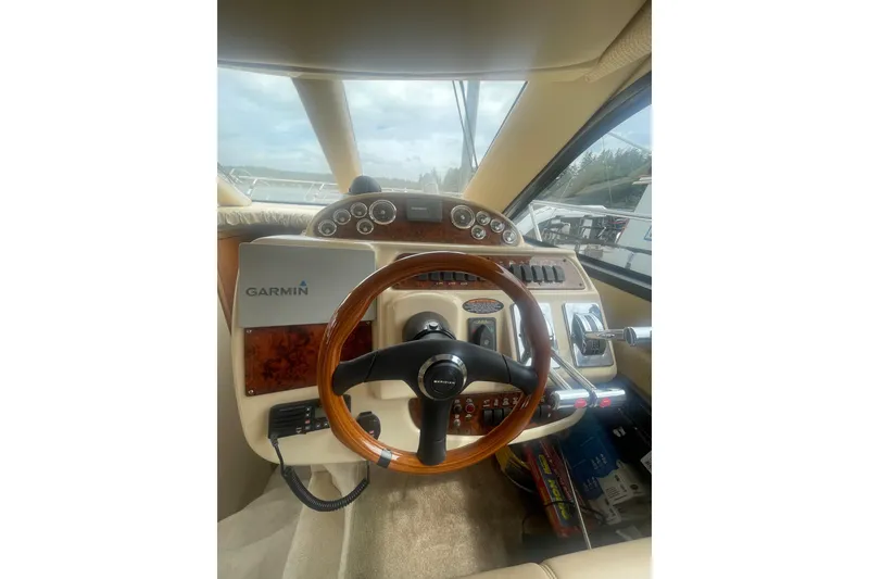 Slide: The Image of 2004 Meridian 341 Sedan helm with Garmin navigation and wood-accented steering wheel. - 27